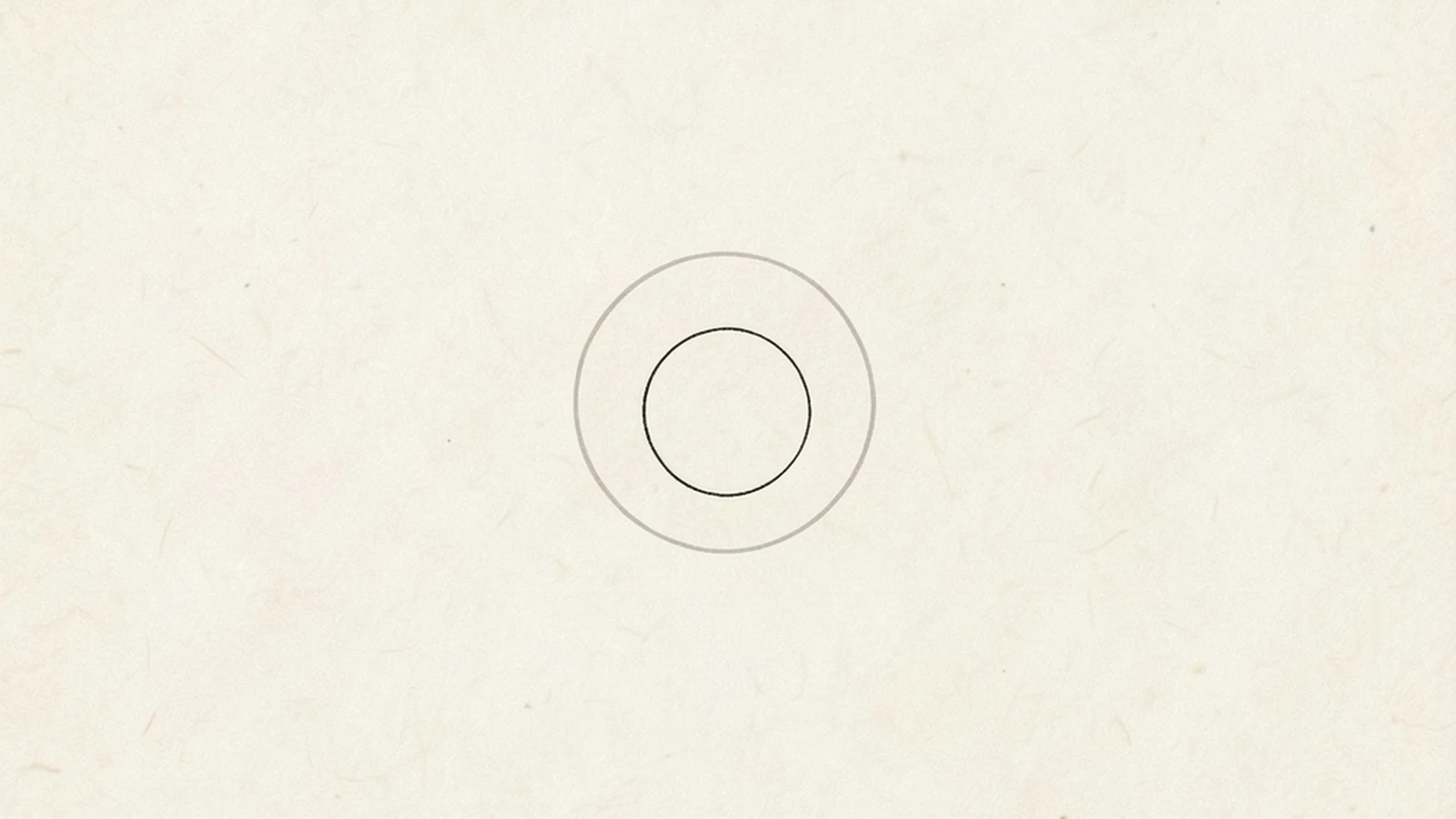 A minimal illustration of a small empty circular outline sitting concentrically inside a larger, fainter circular outline, on a large pale empty ground